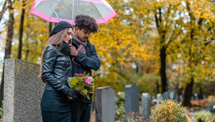 couple in grief on a cemetery