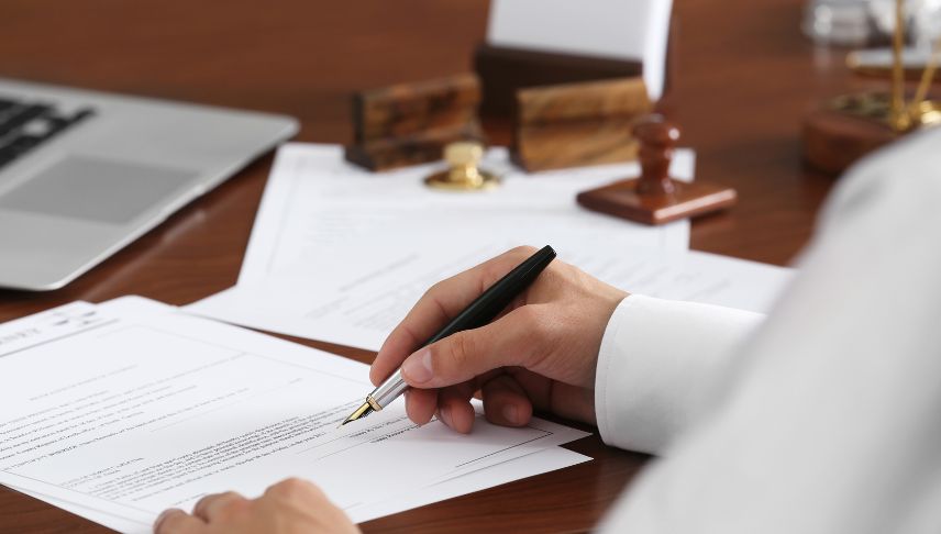 personal injury lawyer signing legal documents