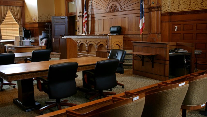 courtroom with chairs tables and flags