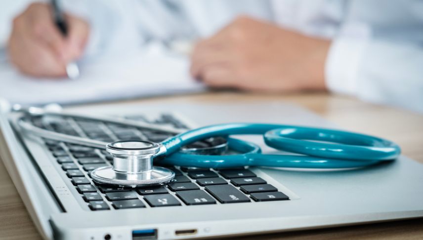 laptop with stethoscope on blurred background