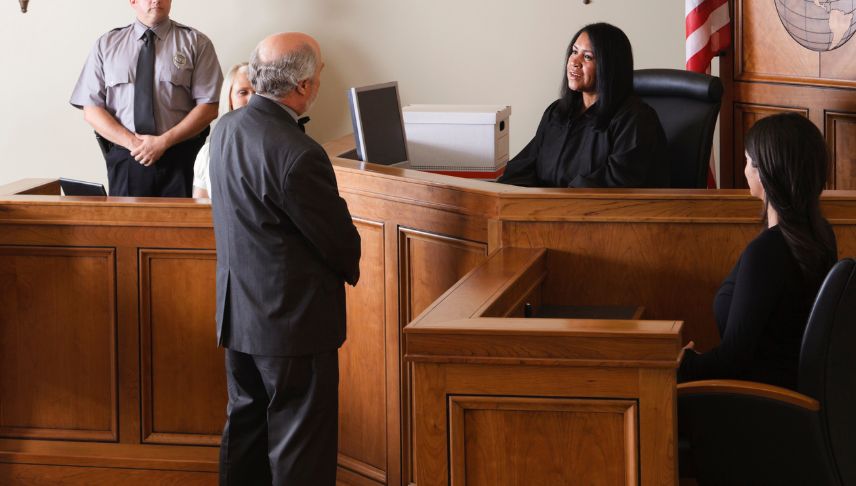 lawyer talking to judge in courtroom