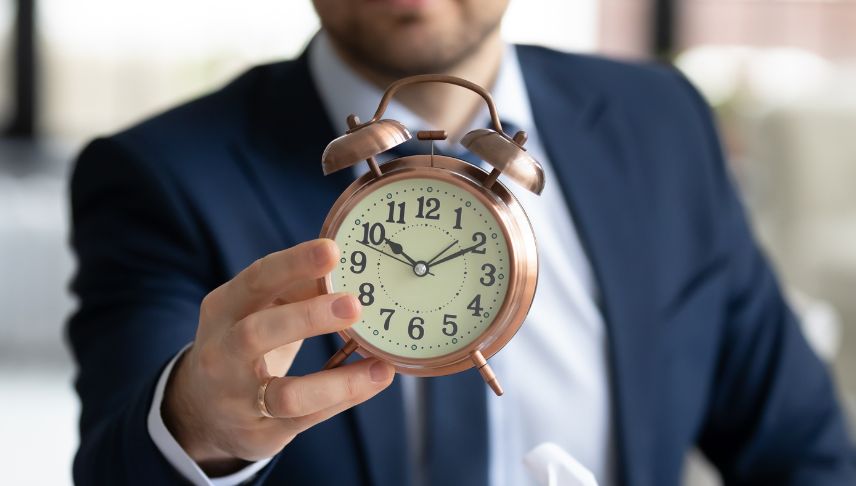 close up of businessman holding clock