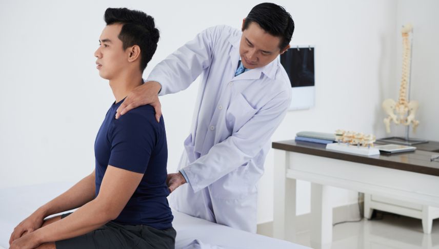 doctor checking the spine of the patient