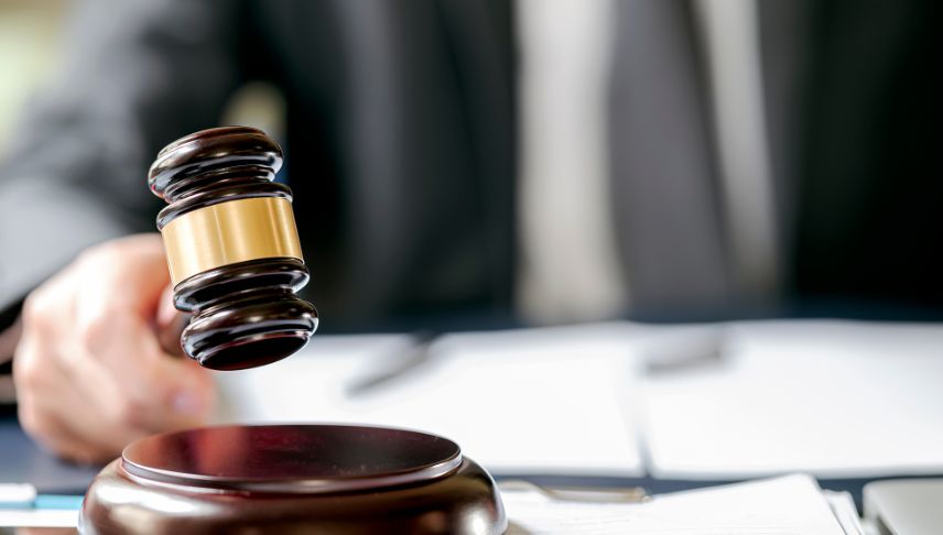 judge holding gavel making decision in court