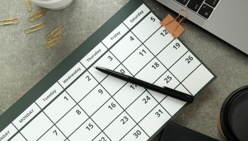 laptop calendar and pen on table
