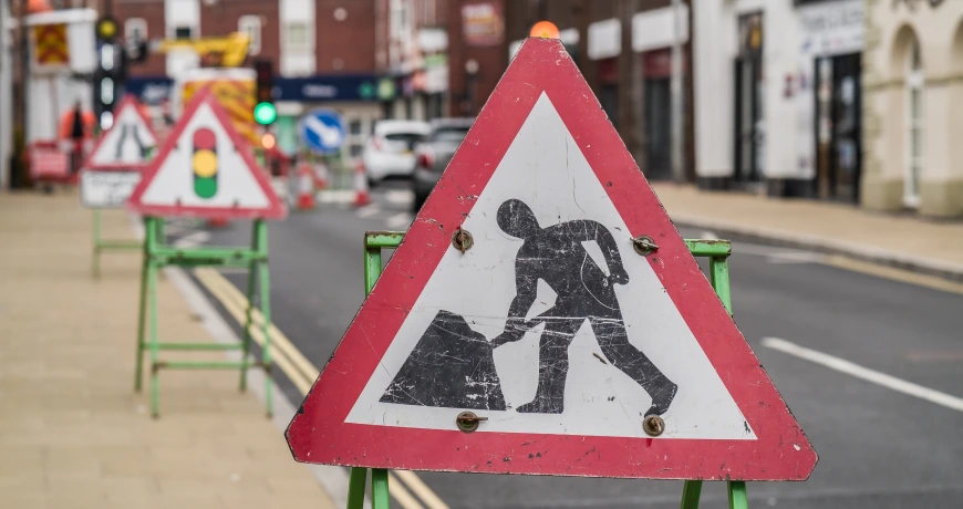 multiple road work signs in the street