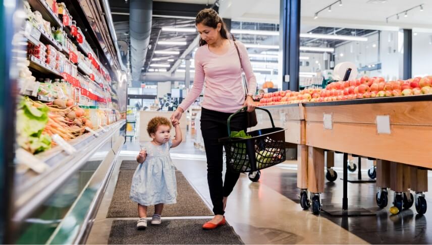 mother walking her child in grocery store