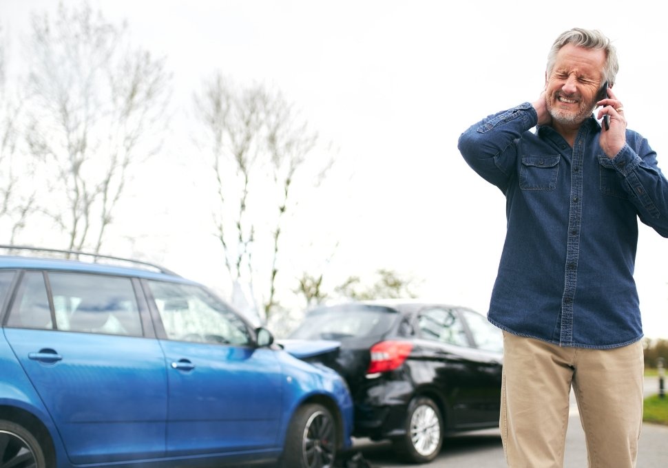 man calling police after a car accident
