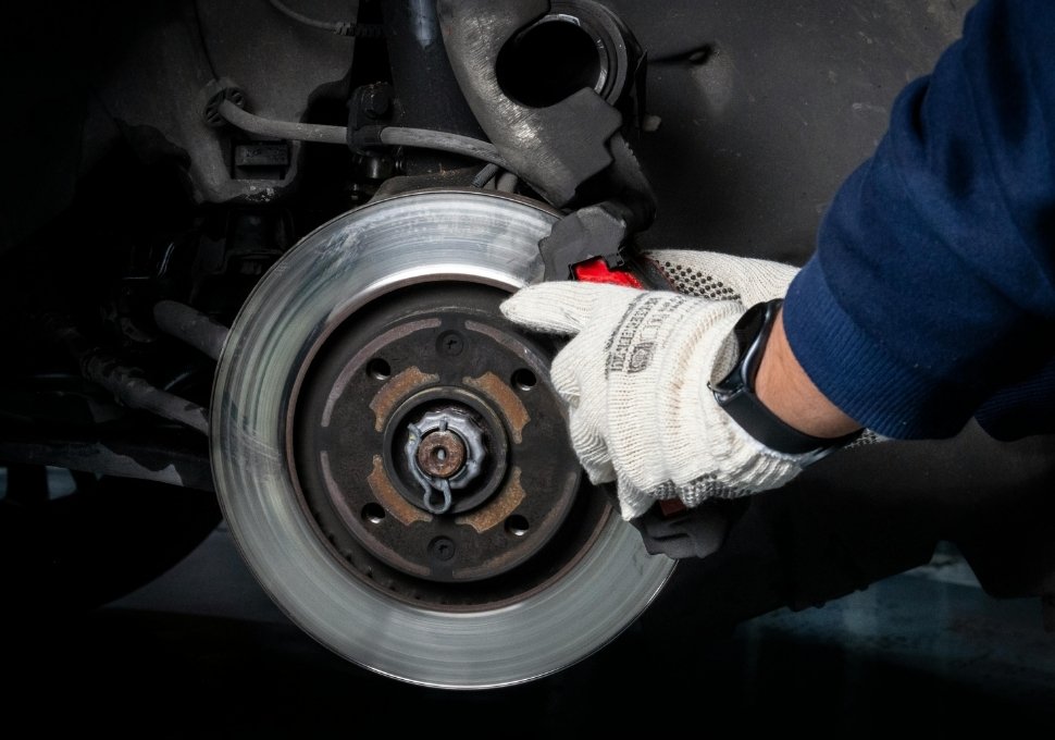 mechanic fixing a car braking system